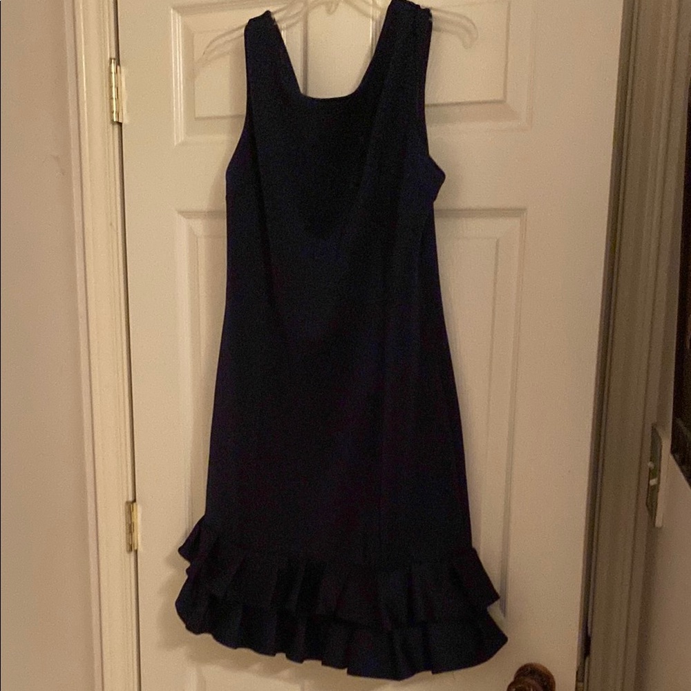 Elegant Navy Blue Sleeveless Dress with Ruffle Hem. Great as office attire.